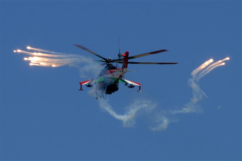 HUAF Mi-24 display with flares blue sky.jpg